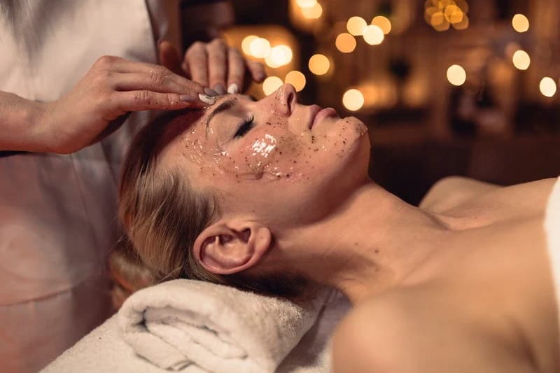 Facial treatment applied to a reclining guest